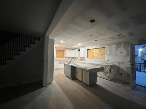 Under construction interior with exposed walls and stairs.