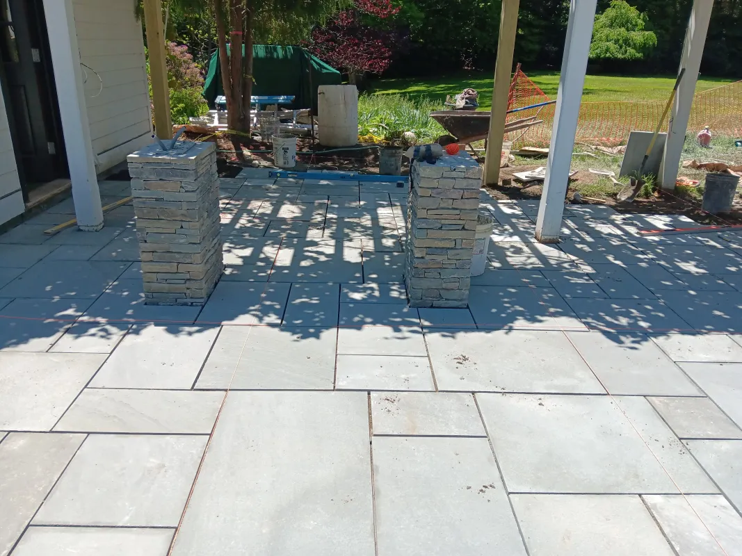 Stone pillars on newly laid patio deck.